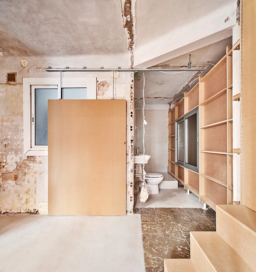 TAKK exposes old partitions + electrical installations in energy-conscious barcelona revamp