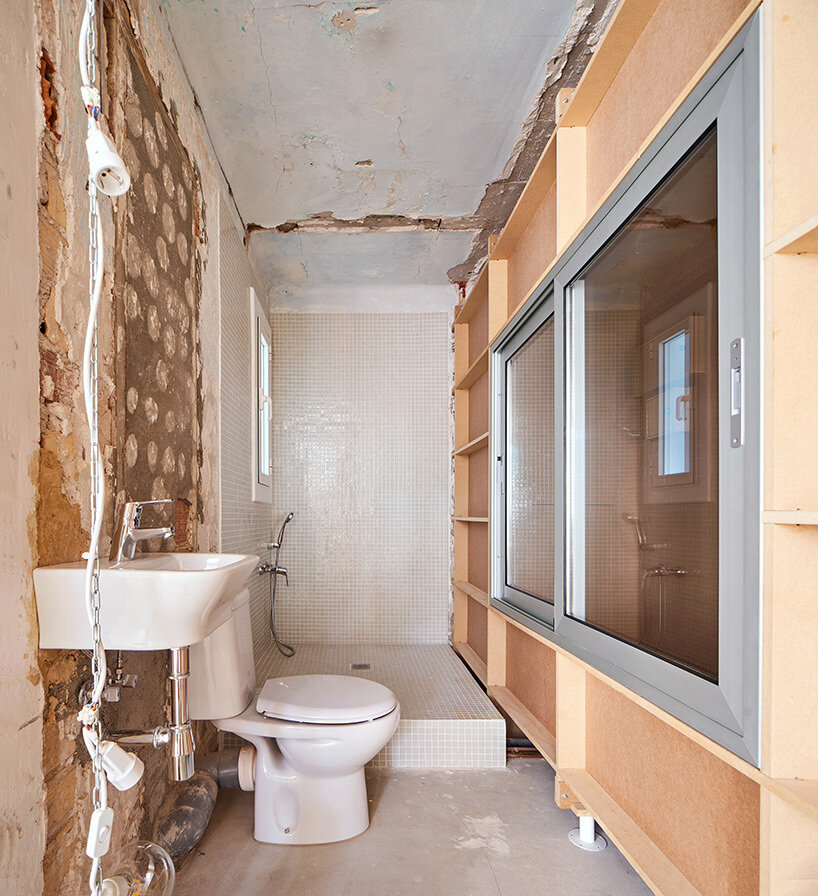 TAKK exposes old partitions + electrical installations in energy-conscious barcelona revamp