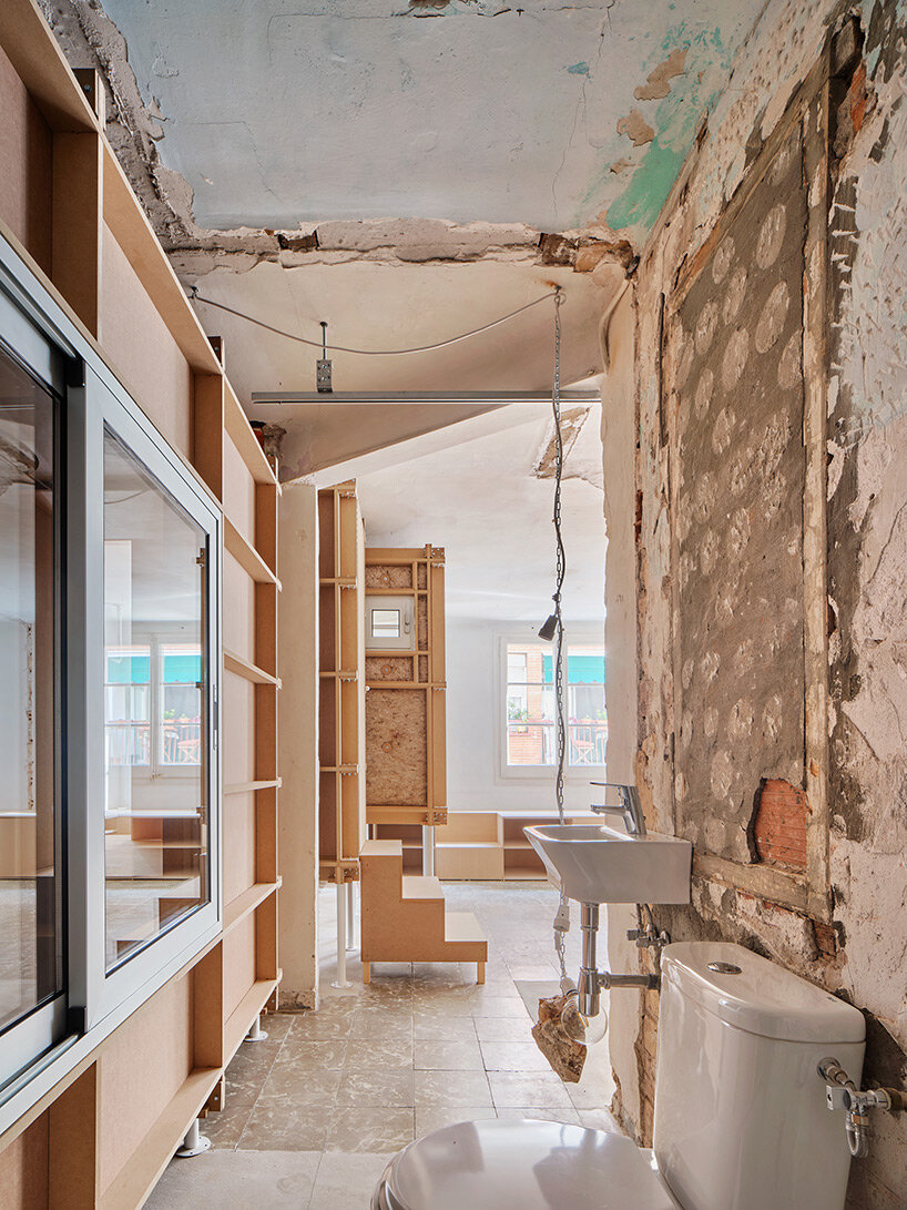 TAKK exposes old partitions + electrical installations in energy-conscious barcelona revamp