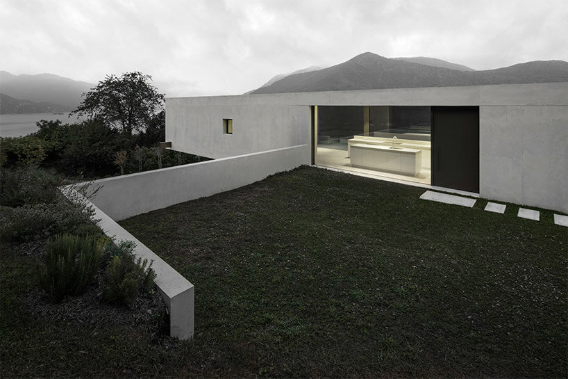 cantilevered concrete house by bergmeisterwolf emerges as a monolith carved into the rock
