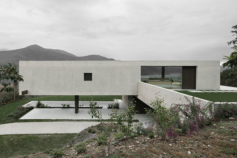 cantilevered concrete house by bergmeisterwolf emerges as a monolith carved into the rock