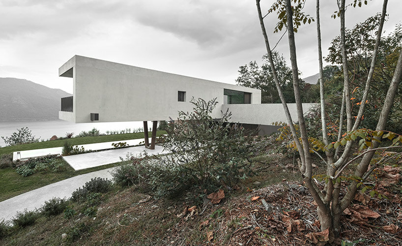 cantilevered concrete house by bergmeisterwolf emerges as a monolith carved into the rock