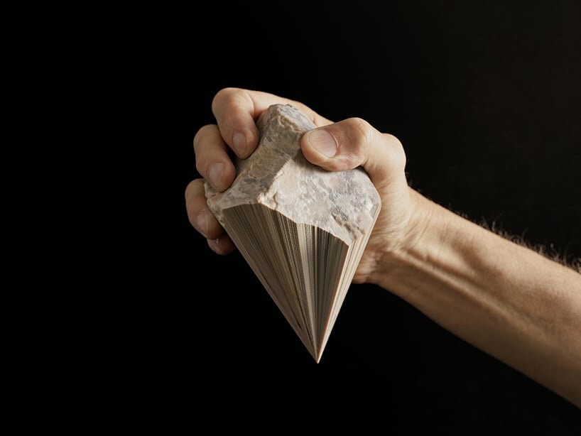A 3D scan of a piece of raw flint was mathematically reduced while in its digital state, to form a point. since the scan included a UV map (color) this too was reduced. full color polyjet print