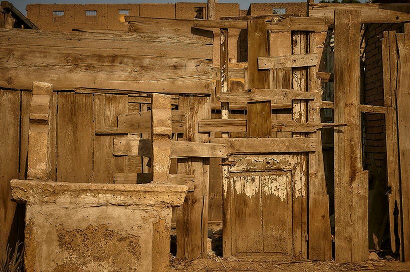 close up of a tomb against a wooden structure