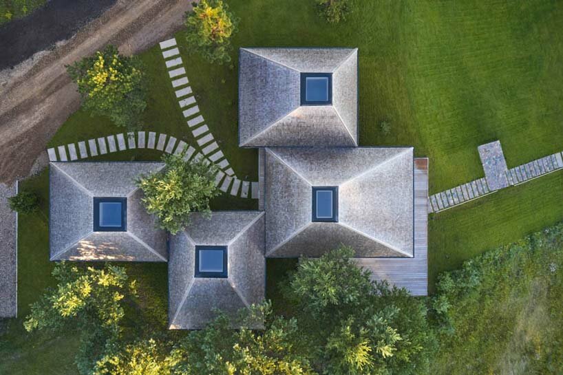 in the picturesque hills of lithuania, a cluster of guest houses by HEIMA gaze skywards