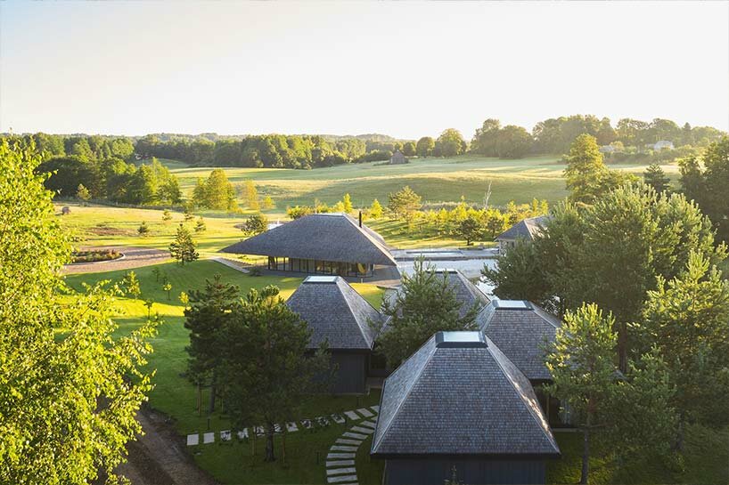 in the picturesque hills of lithuania, a cluster of guest houses by HEIMA gaze skywards