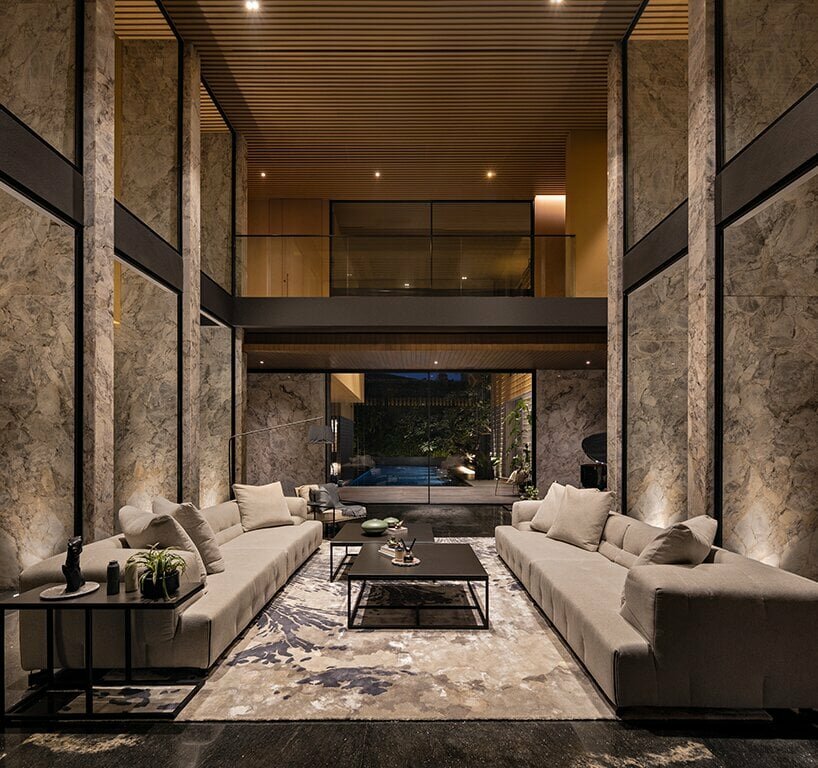polished ironwood flooring, slabs of honed silver marble, and black diamond marble adorn the living room