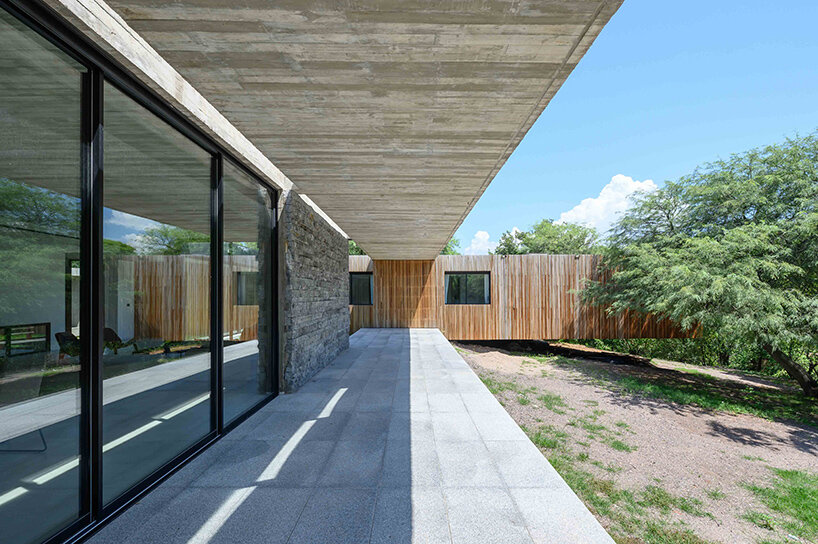 floating in argentina’s forests, this ‘LS house’ is flooded with patterned shadows