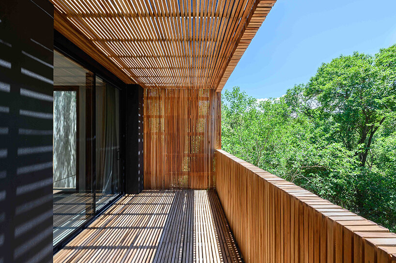 floating in argentina’s forests, this ‘LS house’ is flooded with patterned shadows