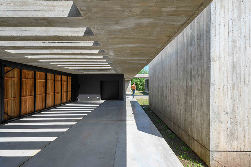 floating in argentina’s forests, this ‘LS house’ is flooded with patterned shadows