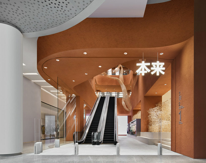 woven bamboo installation by AIM architecture drapes over fashion store atrium in china