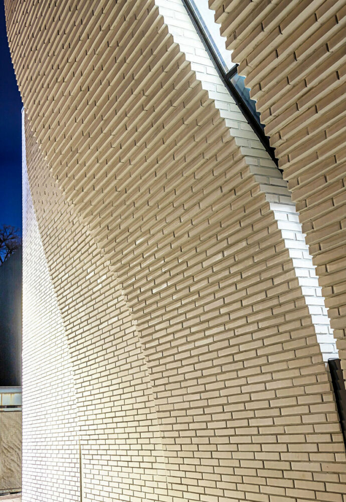 a curved brick wall ripples across LESS architects’ office building design in seoul