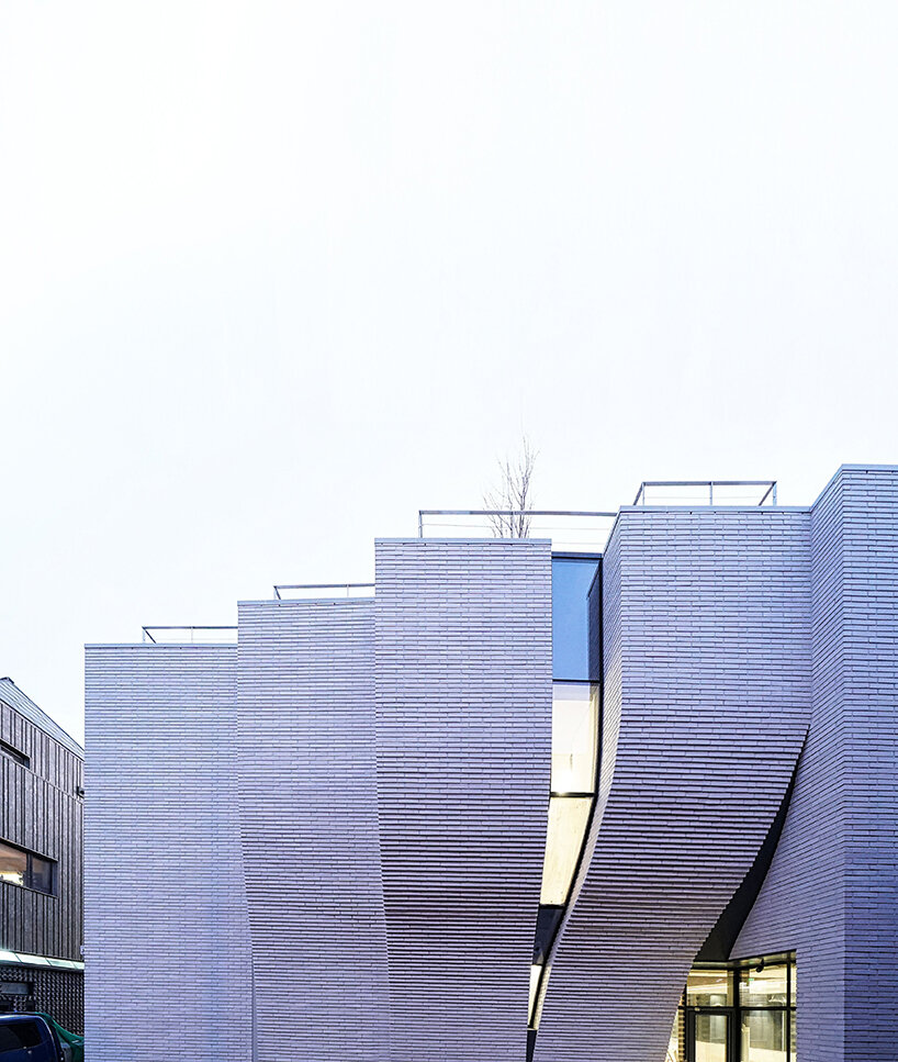 a curved brick wall ripples across LESS architects’ office building design in seoul