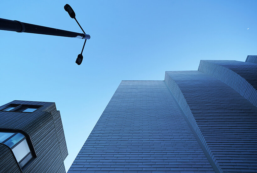 a curved brick wall ripples across LESS architects’ office building design in seoul
