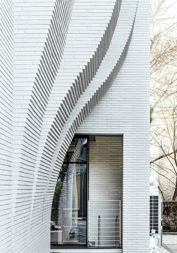 a curved brick wall ripples across LESS architects’ office building design in seoul