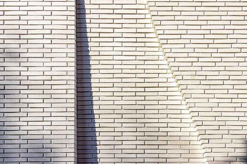 a curved brick wall ripples across LESS architects’ office building design in seoul