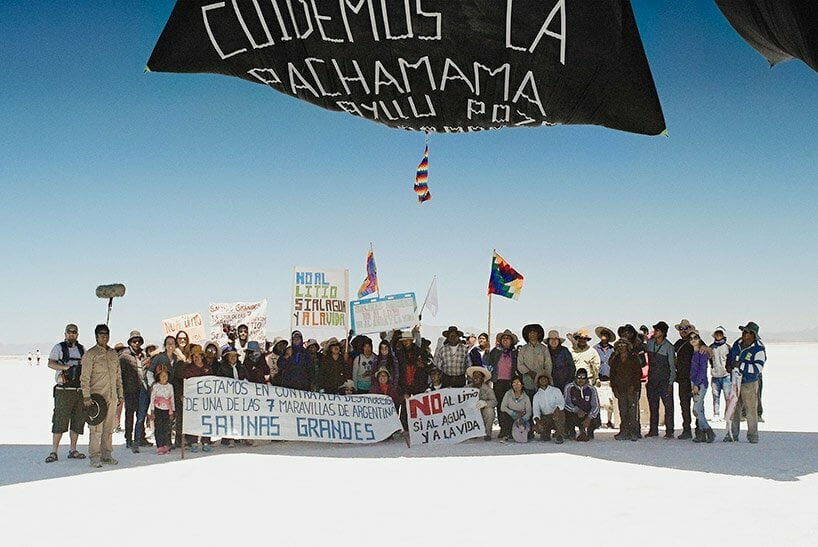 Members of the Indigenous Communities of Salinas Grandes and Laguna de Guayatayoc defend their land against lithium extraction during the Fly with Aerocene Pacha project in January 2020. The signs read: ‘Let’s take care of Pachamama…’; ‘We are against the destruction of one of Argentina’s 7 wonders. Salinas Grandes’; ‘No to lithium, yes to water and life’ Courtesy of the Aerocene Foundation. Photography by Studio Tomás Saraceno