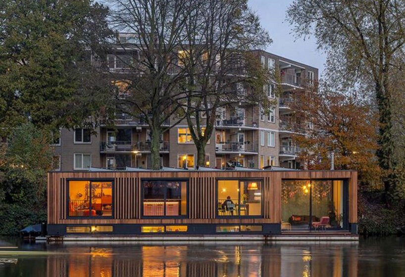 floating wooden houseboat by EVA architecten embraces canal views in utrecht