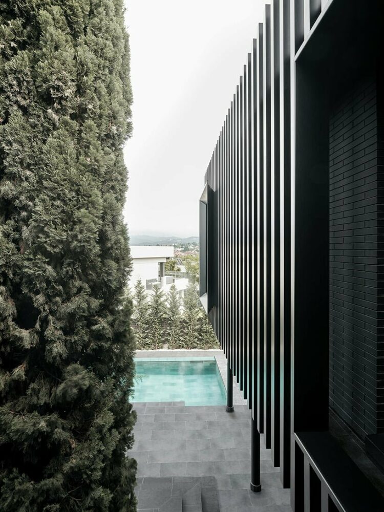 black monochrome envelope and vertical steel slats modernize family home in barcelona