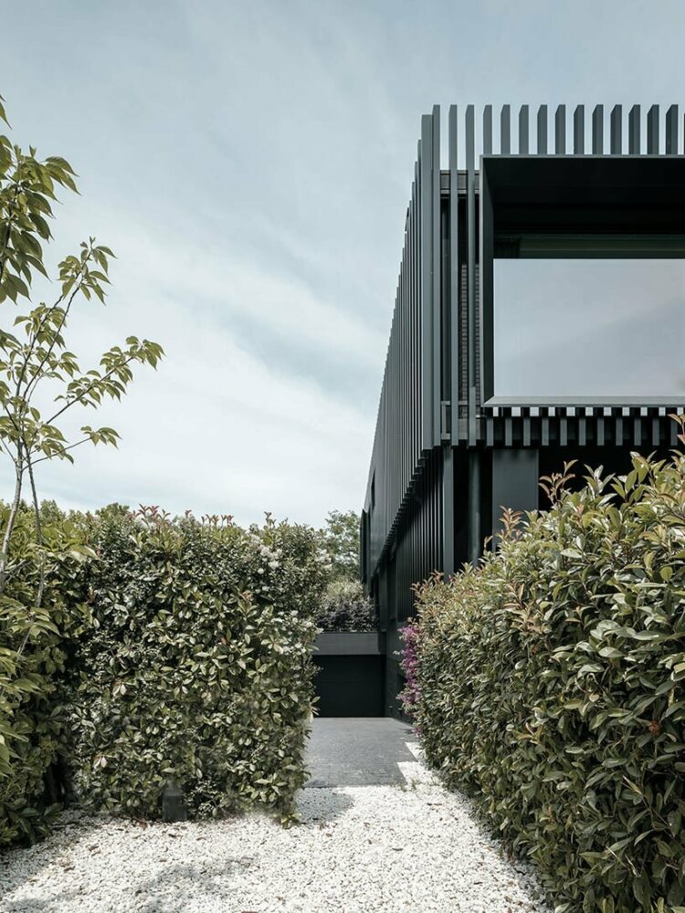 black monochrome envelope and vertical steel slats modernize family home in barcelona