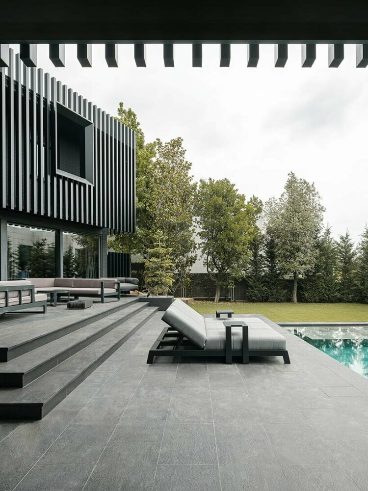 black monochrome envelope and vertical steel slats modernize family home in barcelona