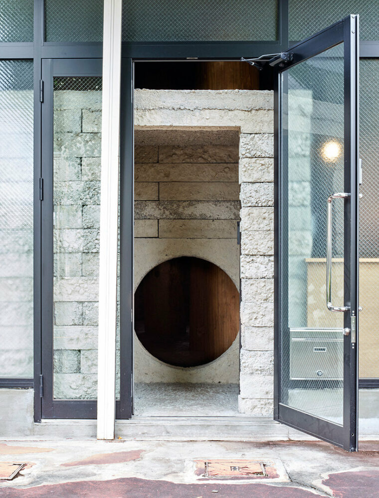 large tree trunks arrow through tomoaki uno’s peaceful forest-like office in japan