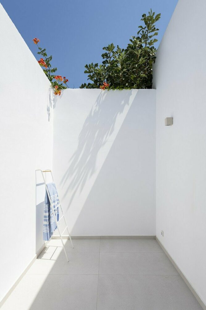 marble inlays adorn spolia house’s pure white facade in greek island