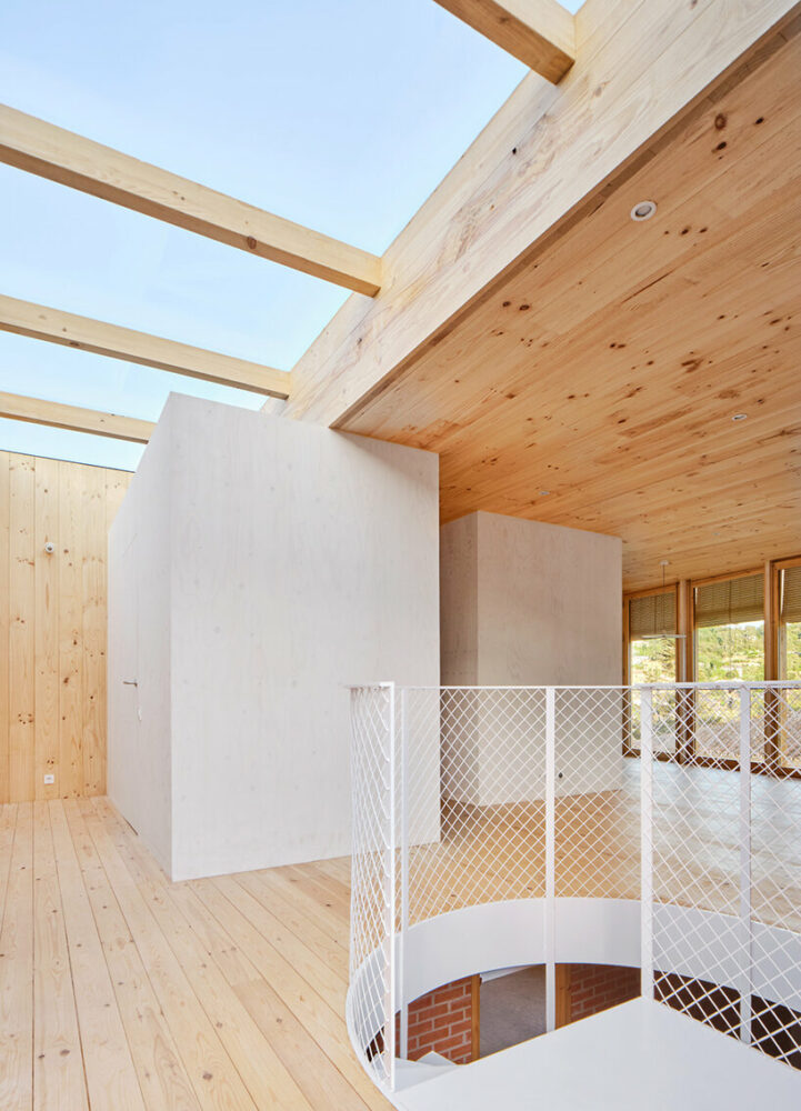 ágora arquitectura stacks cross laminated timber house atop old brick base in spain