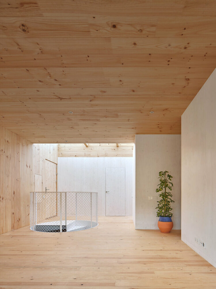 ágora arquitectura stacks cross laminated timber house atop old brick base in spain