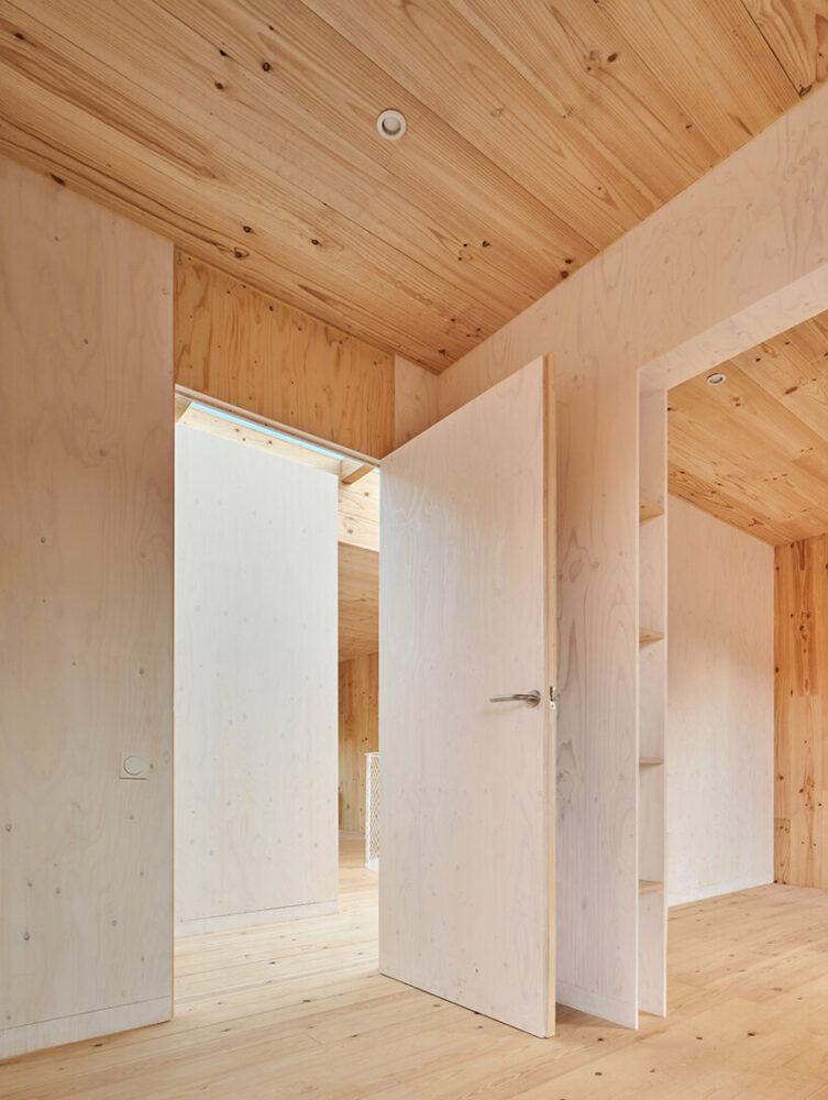 ágora arquitectura stacks cross laminated timber house atop old brick base in spain