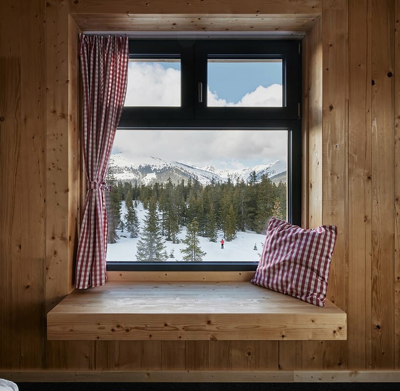 the window openings are equipped with wooden seating areas for the students