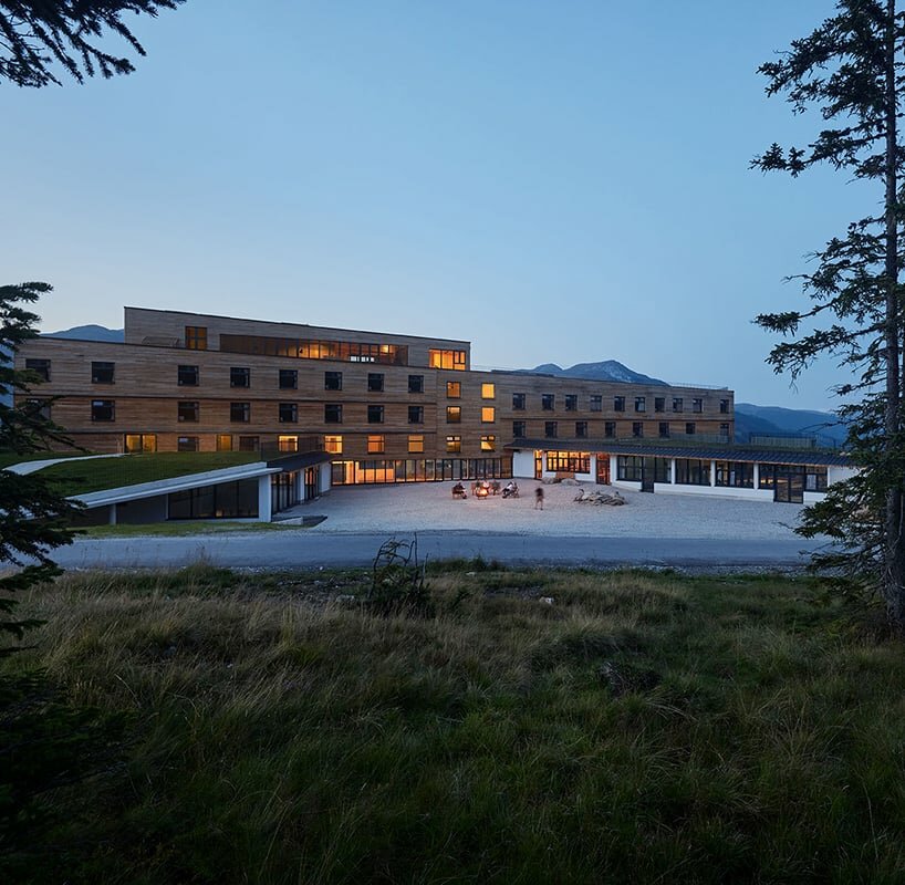 larch wood slabs wrap around the youth hostel