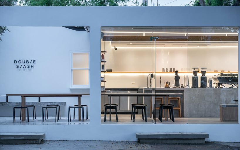spacy architecture wraps serene bangkok cafe in floating glass