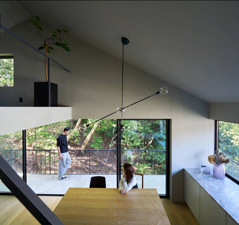 airhouse's wooden home floats above a steep slope in the japanese forest 