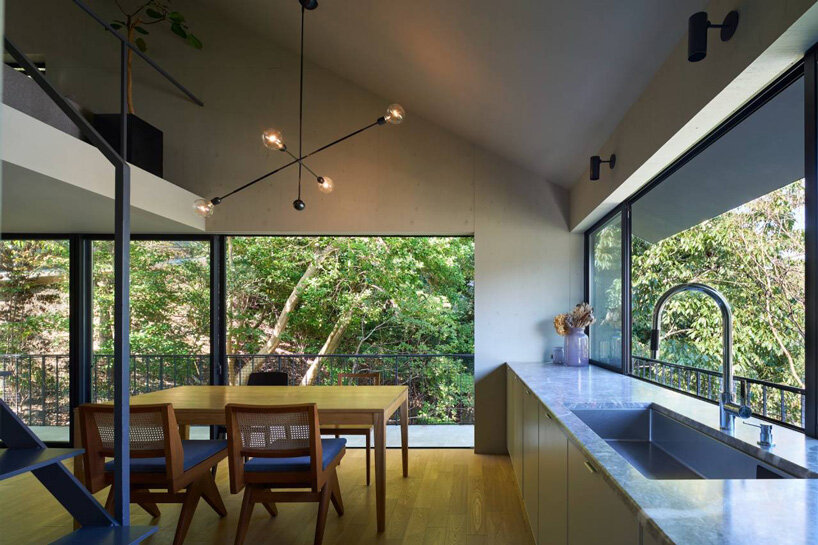 airhouse's wooden home floats above a steep slope in the japanese forest 