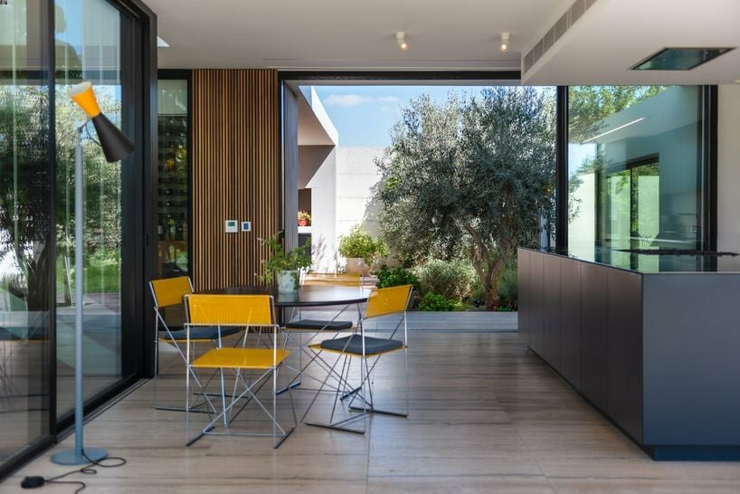the kitchen area is extended to a private courtyard that serves as an integral part of the interior