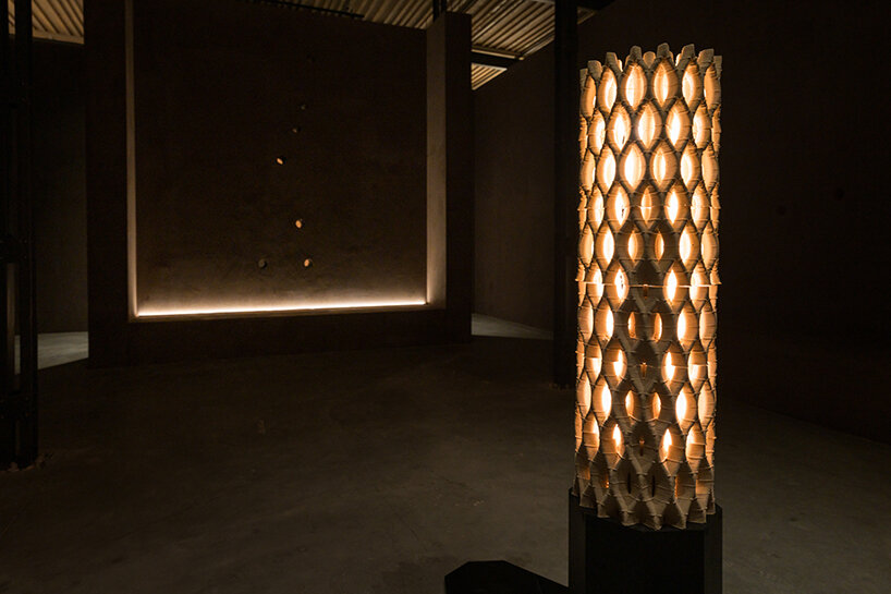 a 3D-printed clay column projecting mystical light patterns