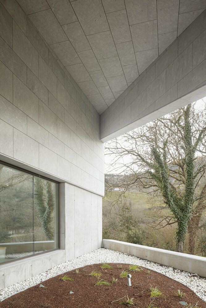 a folded stone roof crowns this visitor center in the spanish hillside