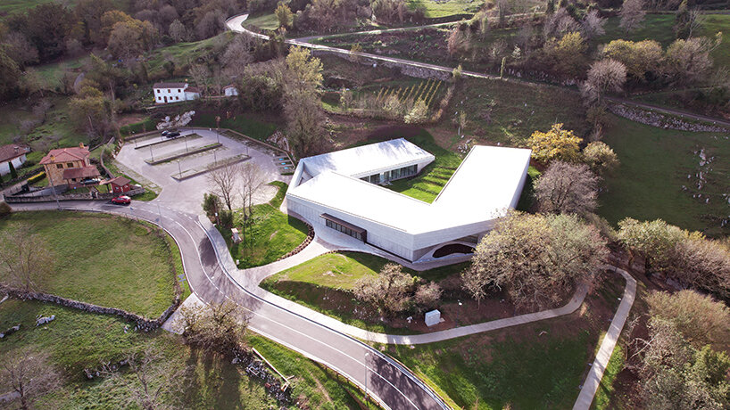 a folded stone roof crowns this visitor center in the spanish hillside