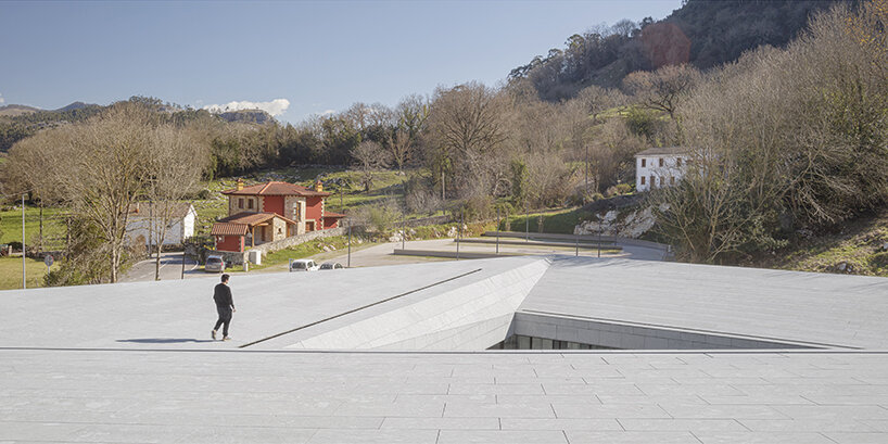 a folded stone roof crowns this visitor center in the spanish hillside