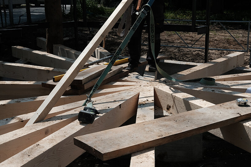 charly jolliet’s umbrella-shaped canopy in switzerland spotlights traditional wood cladding