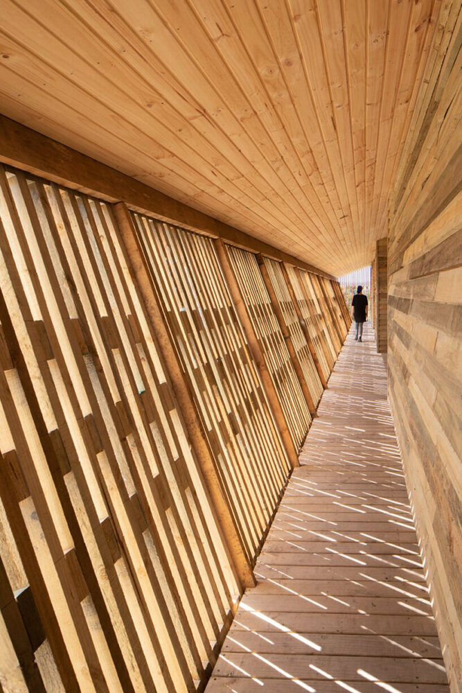chilean home wraps in latticed semi-external corridor to combine private + commercial living