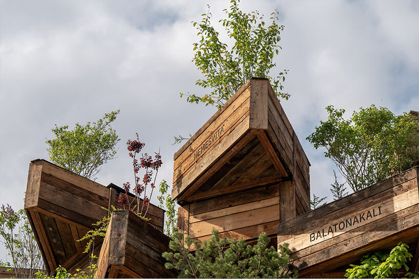 hello wood stacks triangular lush planters for the garden of communities installation