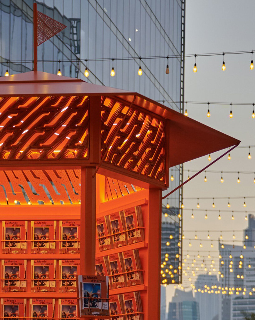 MEAN* wraps traveling hermès pop-up in vivid orange 3D-printed tessellation