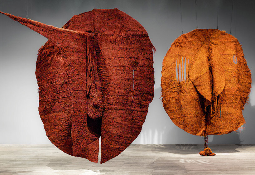 woven biomorphic sculptures by magdalena abakanowicz hover inside MCBA, switzerland
