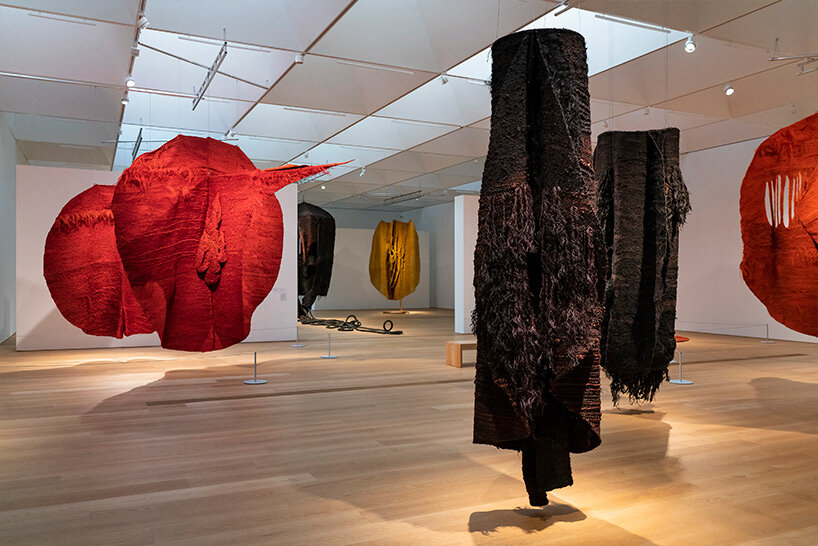woven biomorphic sculptures by magdalena abakanowicz hover inside MCBA, switzerland
