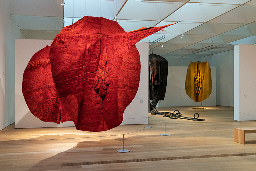 woven biomorphic sculptures by magdalena abakanowicz hover inside MCBA, switzerland