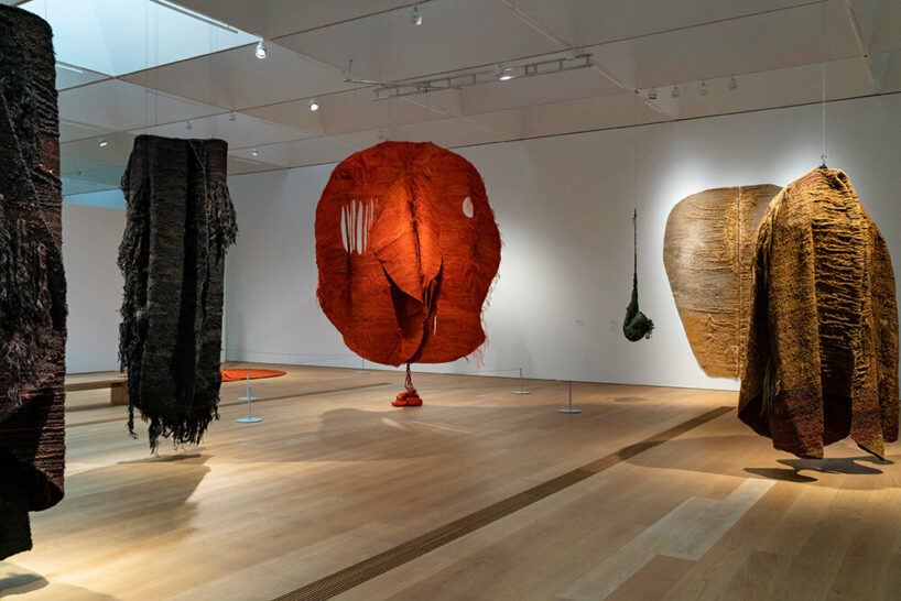 woven biomorphic sculptures by magdalena abakanowicz hover inside MCBA in switzerland