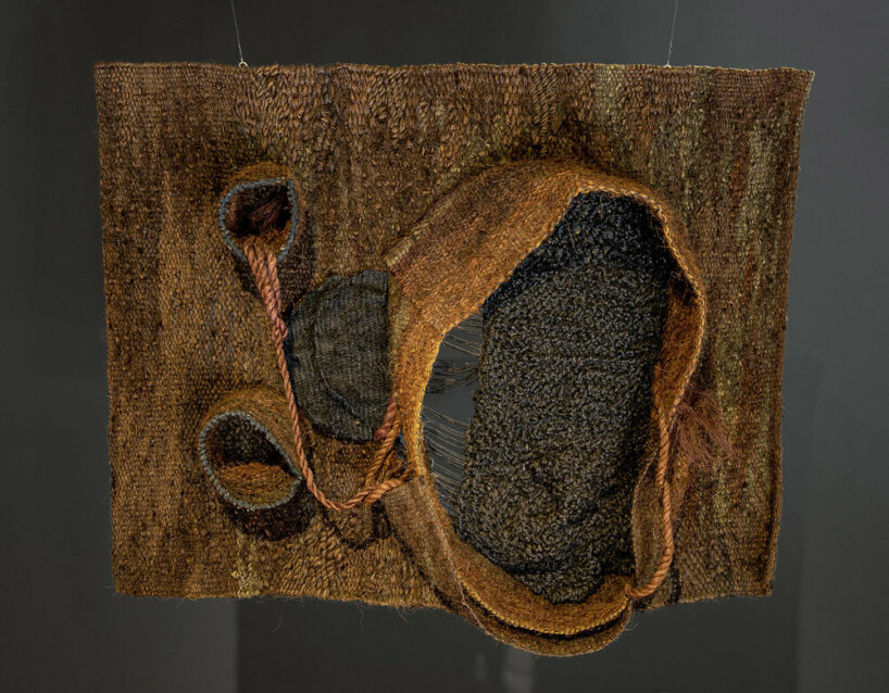 woven biomorphic sculptures by magdalena abakanowicz hover inside MCBA in switzerland