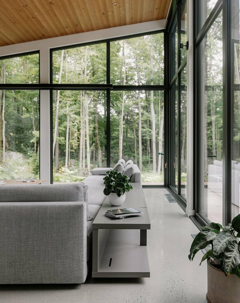 alternating single-slope roofs top oakhill house nestled in canadian dense forest